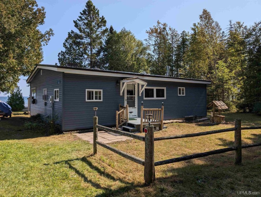 Nestled along 150' of pristine sandy Lake Michigan frontage in - Beach Home for sale in Manistique, Michigan on Beachhouse.com