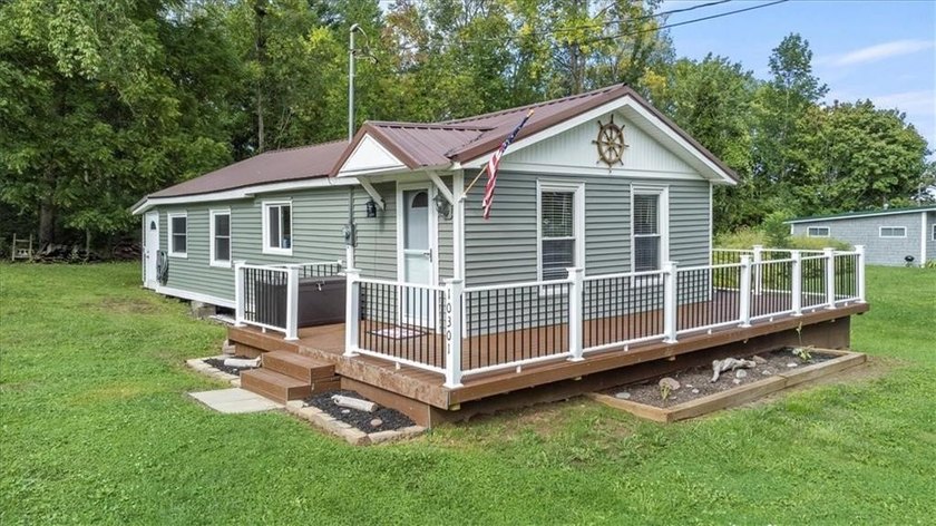 Welcome to your waterfront retreat on East Bay! This charming - Beach Home for sale in Wolcott, New York on Beachhouse.com