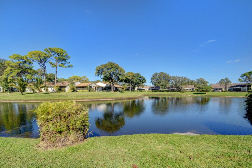 This lake front home has a bright, kitchen that has an island - Beach Townhome/Townhouse for sale in Greenacres, Florida on Beachhouse.com