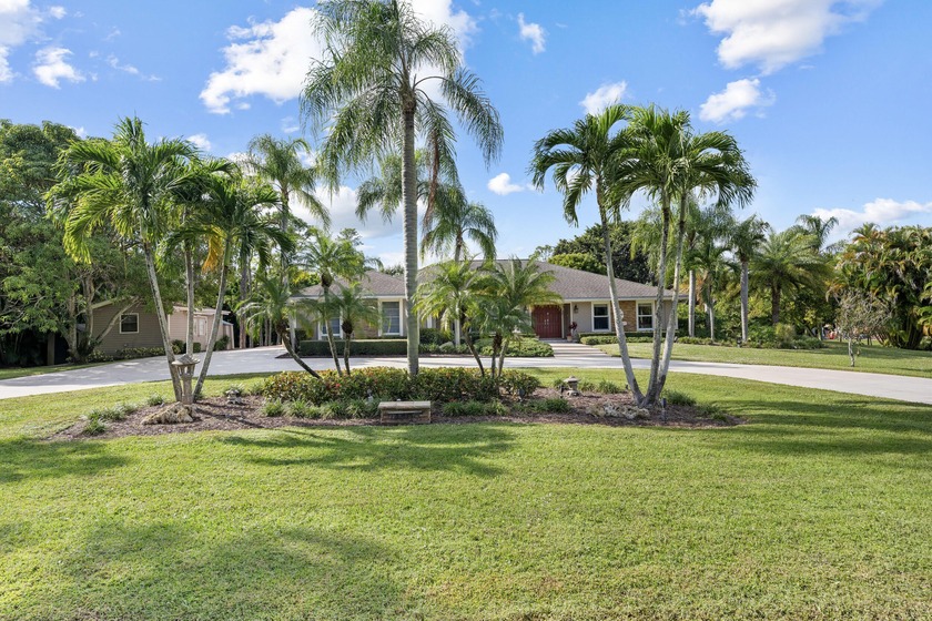 Set on 1.15 acres in Palm Beach Country Estates, this - Beach Home for sale in Palm Beach Gardens, Florida on Beachhouse.com