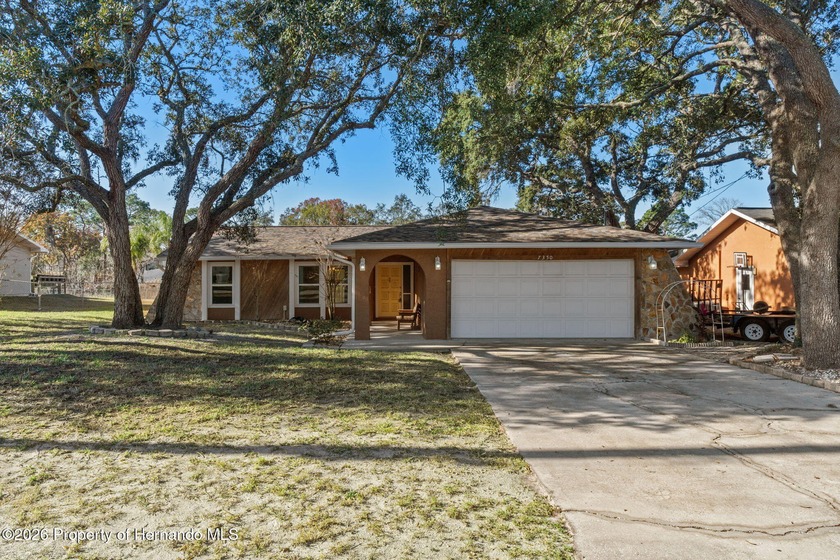 This 3-bedroom, 2-bath home with a 2-car garage sits on a level - Beach Home for sale in Spring Hill, Florida on Beachhouse.com