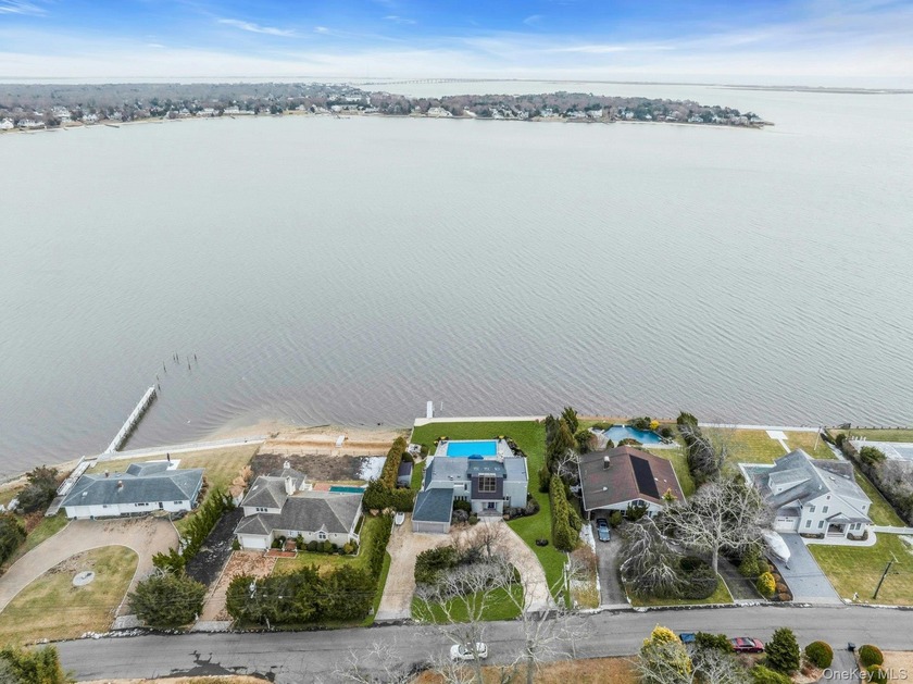 Welcome to 17 Romana Drive, a picturesque bayfront home nestled - Beach Home for sale in Hampton Bays, New York on Beachhouse.com