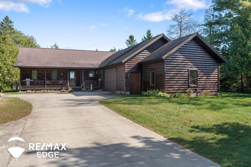 Nestled on the shores of Lake Michigan in Manistique, this - Beach Home for sale in Manistique, Michigan on Beachhouse.com