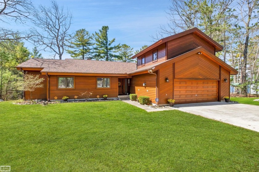 Indulge in the allure of lakeside living with this meticulously - Beach Home for sale in Oscoda, Michigan on Beachhouse.com