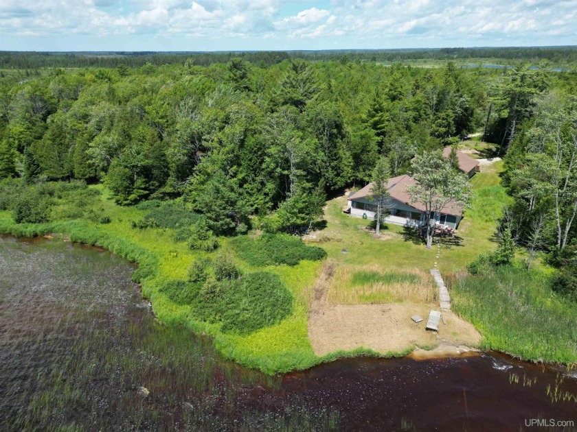 Discover the charm of lakeside living in this serene Indian Lake - Beach Home for sale in Manistique, Michigan on Beachhouse.com