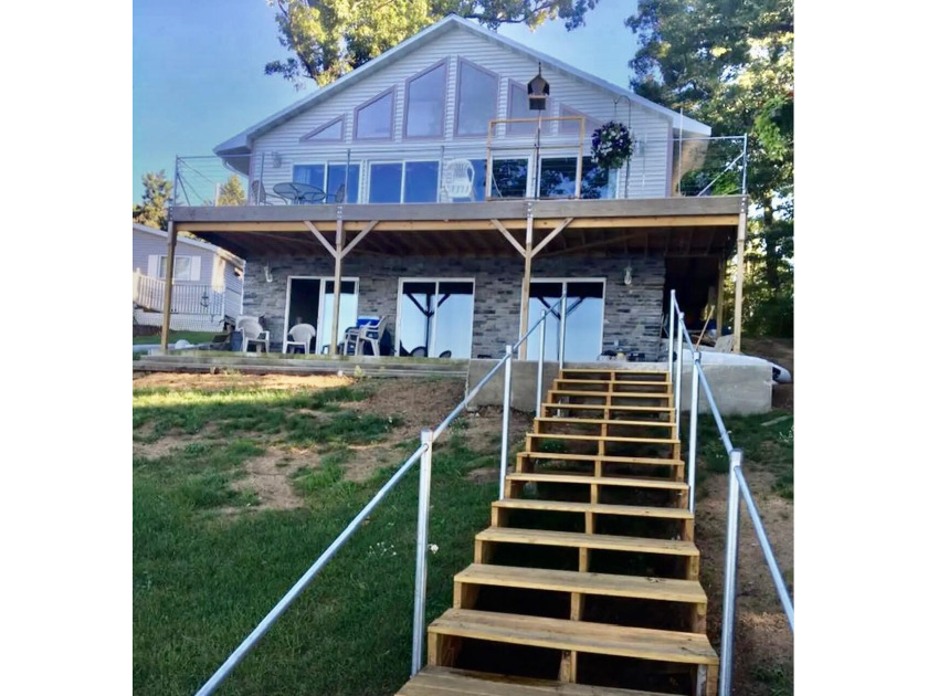 Enjoy lake living! There is 62.58 feet of private sandy beach - Beach Home for sale in Muskegon, Michigan on Beachhouse.com