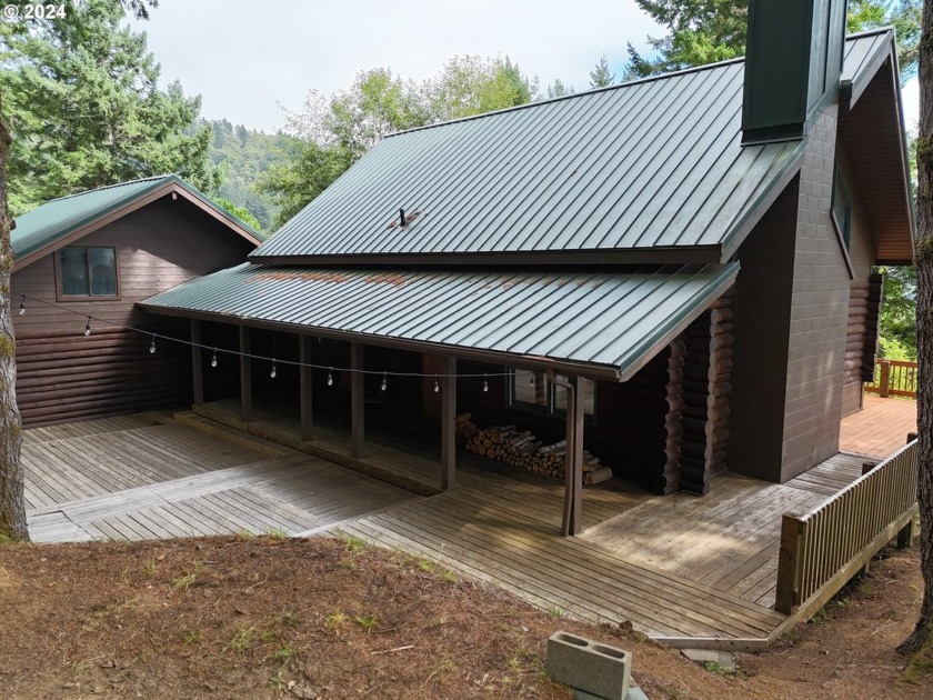 Discover Pacific Northwest charm with this upgraded log home, a - Beach Home for sale in Brookings, Oregon on Beachhouse.com