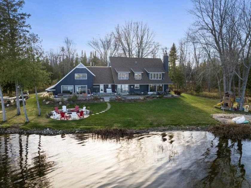 Discover the epitome of lakeside living at 6746 Driftwood Drive - Beach Home for sale in Petoskey, Michigan on Beachhouse.com