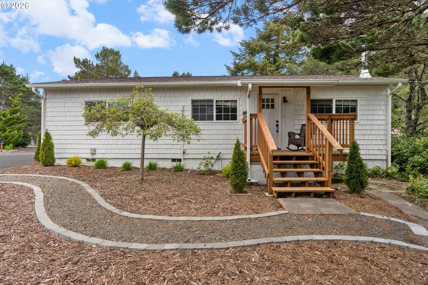 Nestled on a corner lot near the river and North Jetty, this - Beach Home for sale in Florence, Oregon on Beachhouse.com