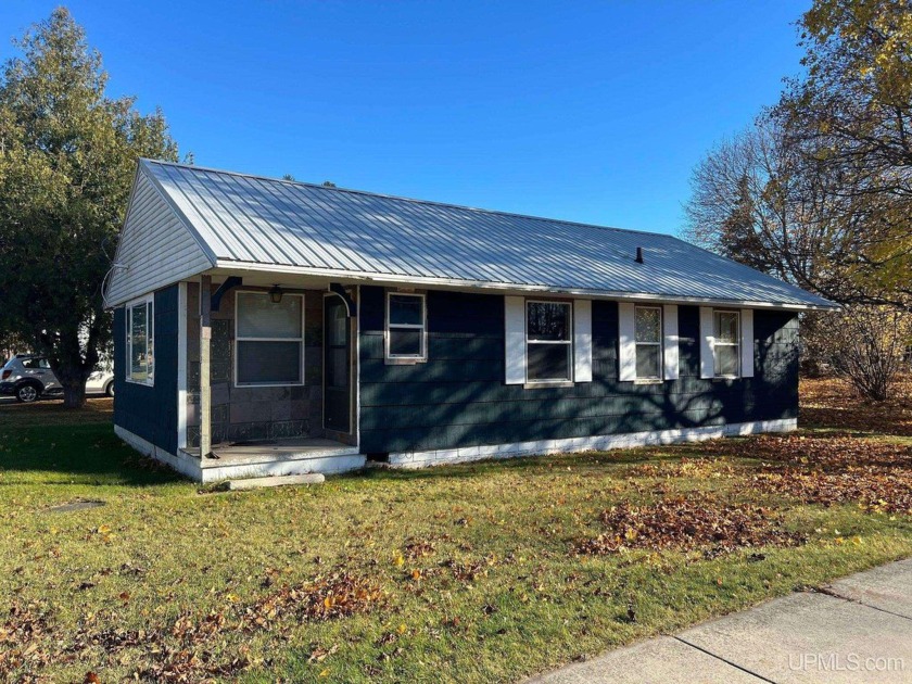 Sitting on a corner lot, just a short walk away from the sandy - Beach Home for sale in Manistique, Michigan on Beachhouse.com