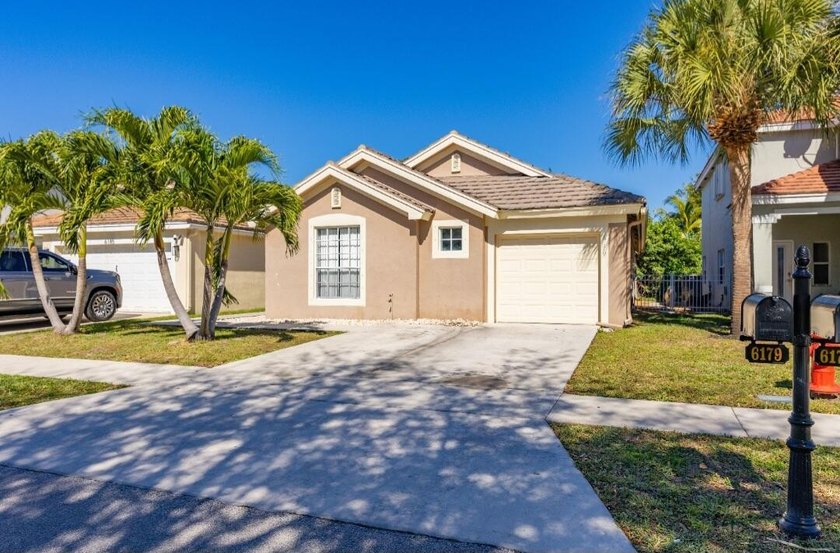 Welcome to this charming 3-bedroom, 2-bathroom home with a 1-car - Beach Home for sale in Lake Worth, Florida on Beachhouse.com