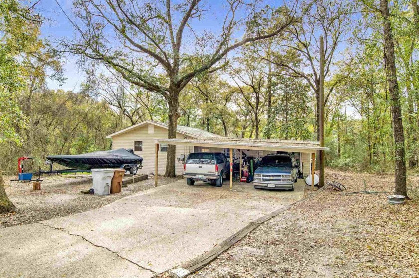 Welcome to this 3-bedroom, 1-bath gem on the peaceful shores of - Beach Home for sale in Milton, Florida on Beachhouse.com