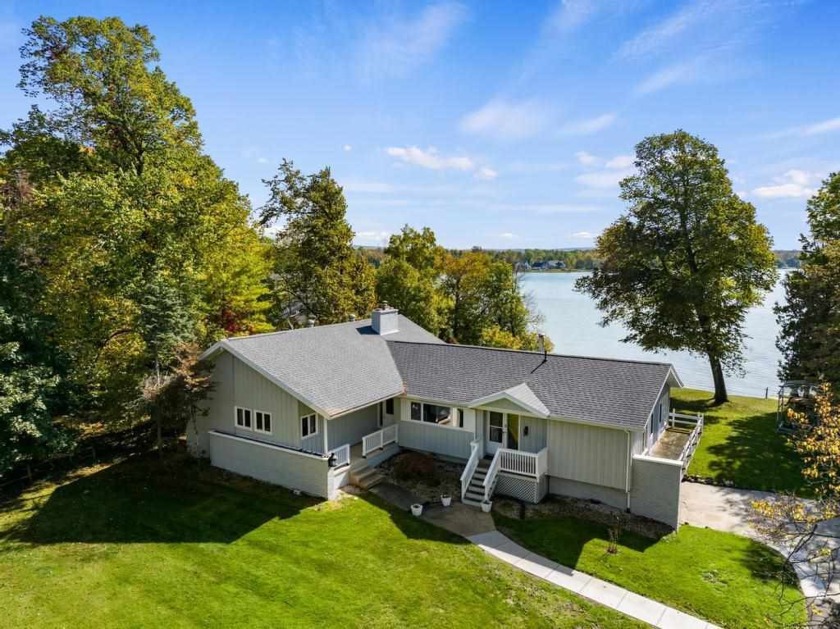 Located on Oden Island, this spacious home offers 120 feet of - Beach Home for sale in Petoskey, Michigan on Beachhouse.com