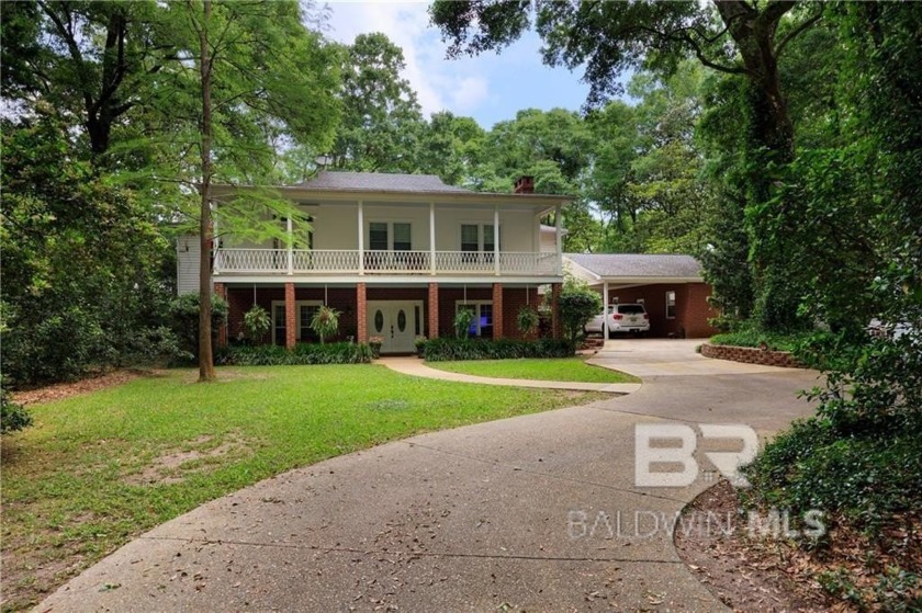 Nestled along the serene shores of Fowl River, this captivating - Beach Home for sale in Theodore, Alabama on Beachhouse.com