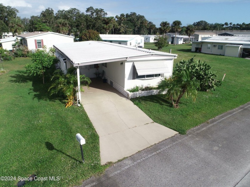 This lovely, manufactured home in Holiday Park 55+ community is - Beach Home for sale in Palm Bay, Florida on Beachhouse.com