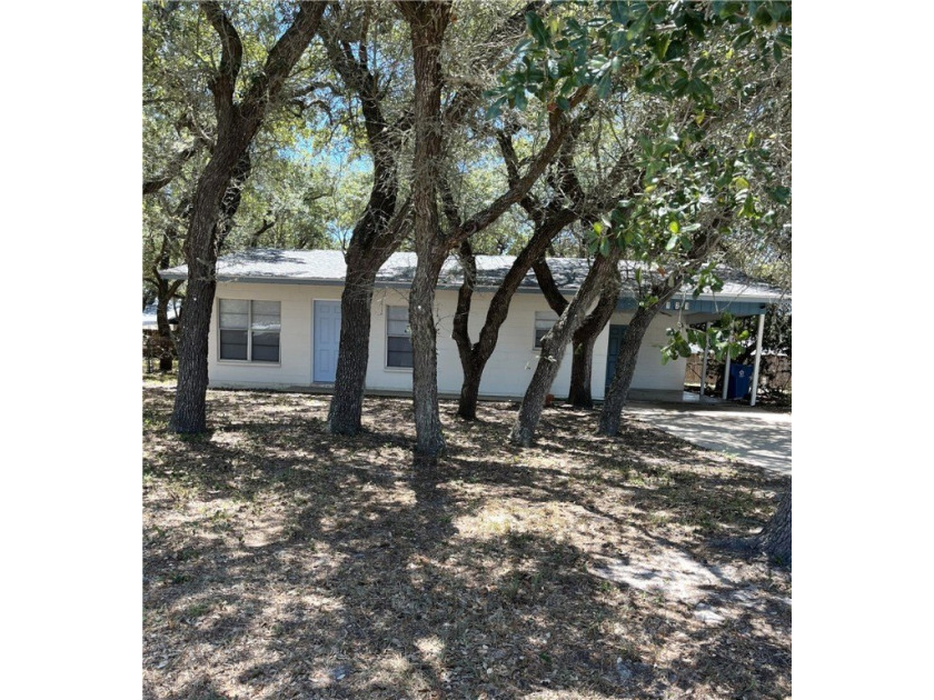 Surrounded by many large oak trees on a spacious corner lot - Beach Home for sale in Rockport, Texas on Beachhouse.com
