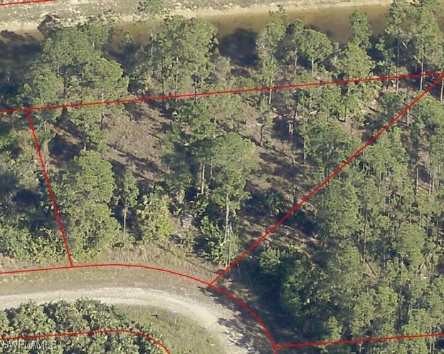 Vacant oversized wooded corner lot, backs to interior canal - Beach Lot for sale in Lehigh Acres, Florida on Beachhouse.com