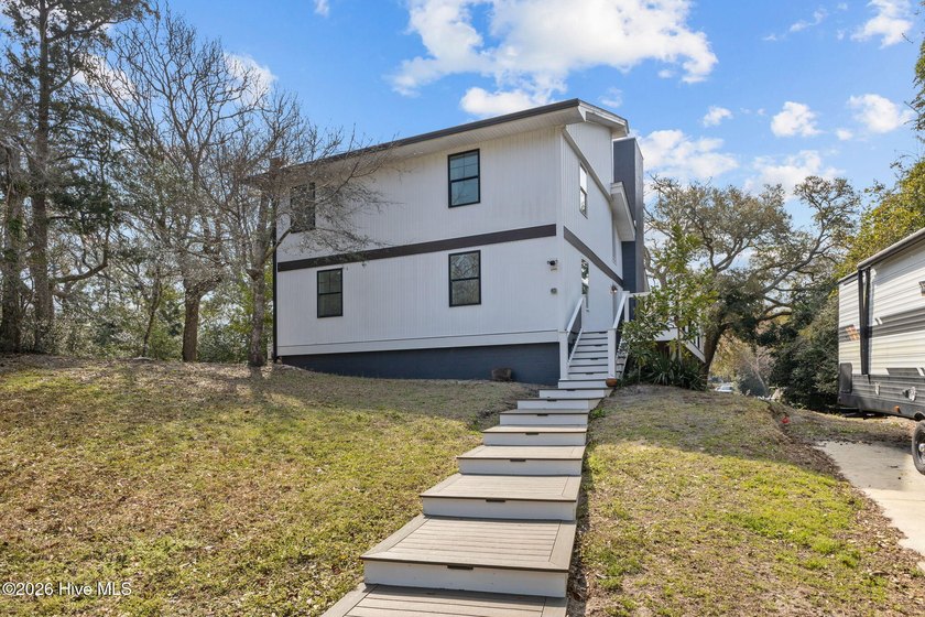 This beautifully designed 5-bedroom, 3-bath canal-front home - Beach Home for sale in Pine Knoll Shores, North Carolina on Beachhouse.com