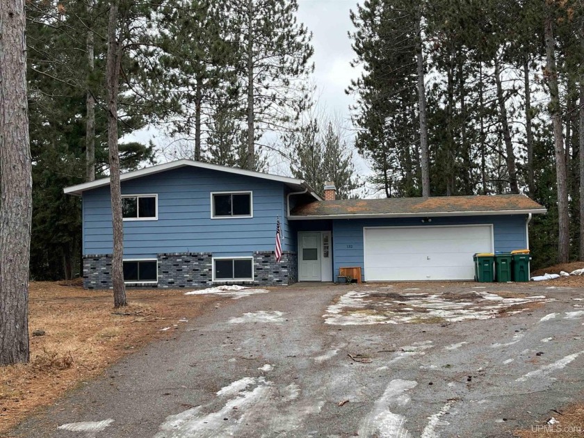 Spacious Bi-Level set on a wooded lot with Chocolay River Bayou - Beach Home for sale in Marquette, Michigan on Beachhouse.com