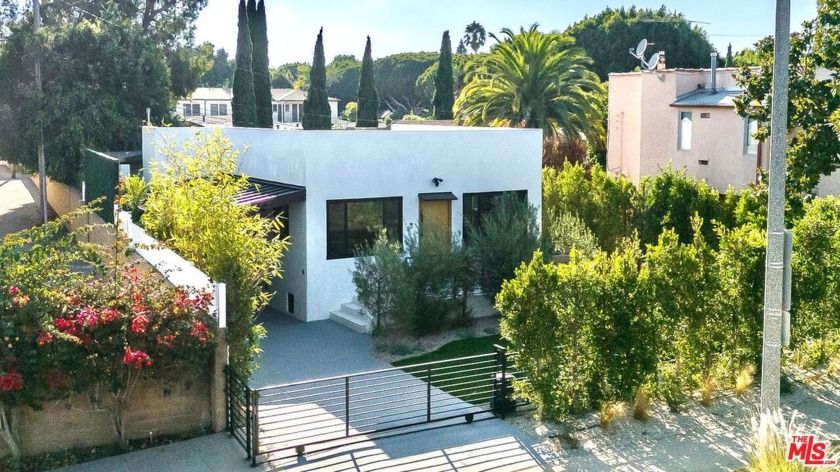 Nestled behind mature privacy hedges and completely gated, this - Beach Home for sale in Santa Monica, California on Beachhouse.com