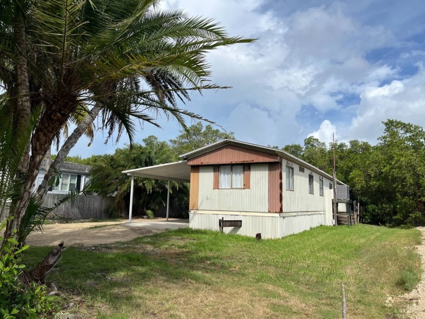 Direct waterfront with a dock and a boat ramp. This three - Beach Home for sale in Plantation Island, Florida on Beachhouse.com