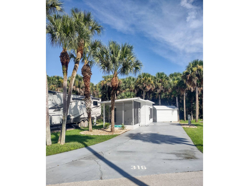 This lovely shaded RV lot with air conditioned 12x8 Florida Room - Beach Home for sale in Titusville, Florida on Beachhouse.com