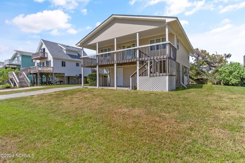 Price Reduction! Enjoy a third-row beach home that has a dock on - Beach Home for sale in Oak Island, North Carolina on Beachhouse.com