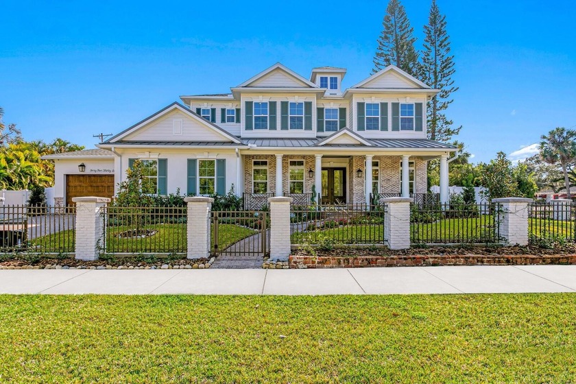 A gated entry framed by a black iron fence, brick columns, stone - Beach Home for sale in Tampa, Florida on Beachhouse.com