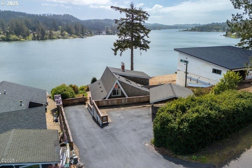 Nestled above the lake, this charming chalet-style home offers a - Beach Home for sale in Neotsu, Oregon on Beachhouse.com