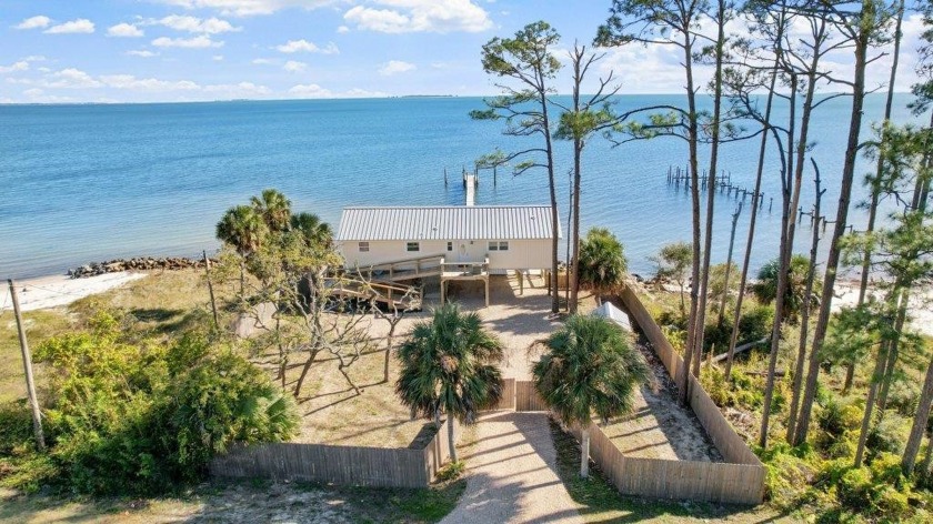 Secluded beach house with deep water dock. House named *Dolphin - Beach Home for sale in Carabelle, Florida on Beachhouse.com