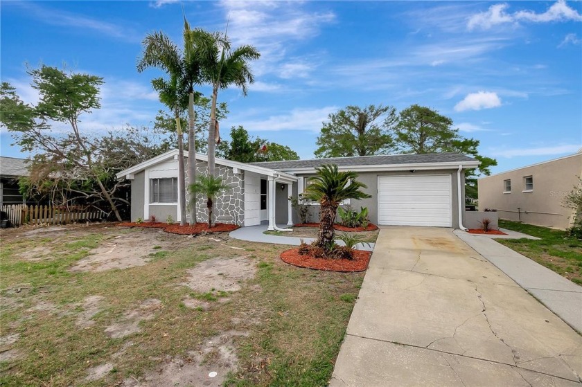 NEWLY REMODELED LAKEFRONT DREAM HOME....  X FLOOD ZONE AND NO - Beach Home for sale in New Port Richey, Florida on Beachhouse.com