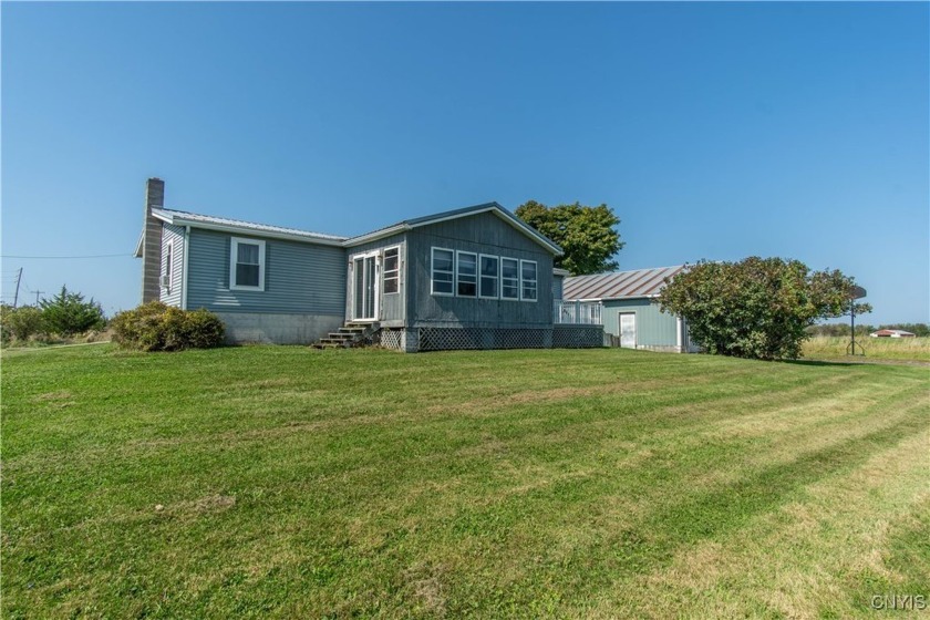 This charming manufactured home sits on a generous 1-acre lot - Beach Home for sale in Henderson, New York on Beachhouse.com