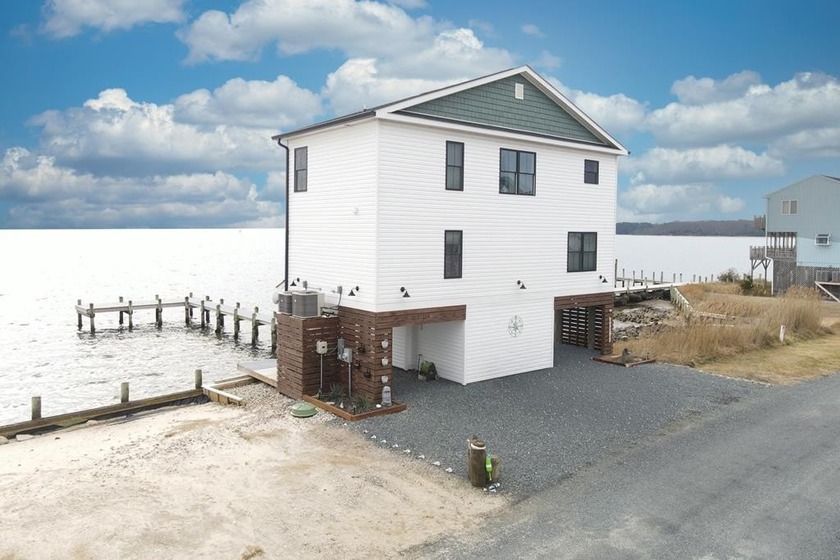 Tucked along the peaceful waters of Chincoteague Bay, this - Beach Home for sale in Greenbackville, Virginia on Beachhouse.com