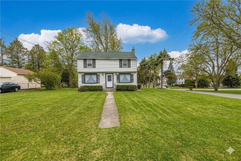 This updated 3-bedroom, 1.5-bath vinyl-sided Colonial is set on - Beach Home for sale in Rochester, New York on Beachhouse.com
