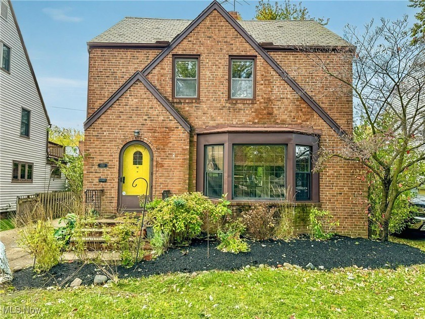 Step into timeless charm with this stately brick Tudor nestled - Beach Home for sale in Euclid, Ohio on Beachhouse.com