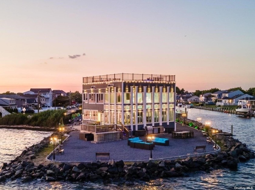 Nestled serenely on the waterfront, this Hampton style home with - Beach Home for sale in Copiague, New York on Beachhouse.com