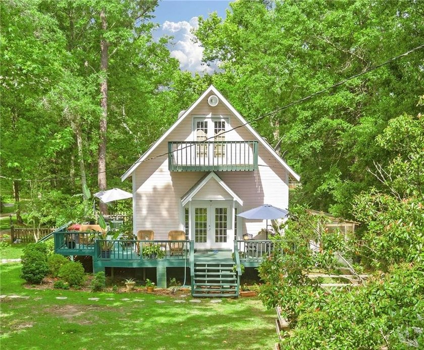 Stunning WATERFRONT home with guest house! Tucked along the - Beach Home for sale in Coden, Alabama on Beachhouse.com