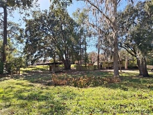 This lovely,  shaded half-acre property offers an inviting older - Beach Home for sale in Hudson, Florida on Beachhouse.com