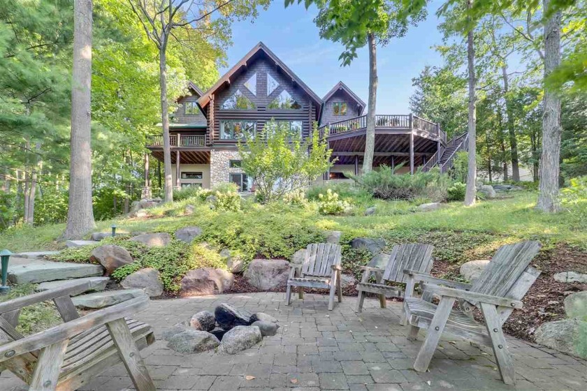 Tucked away along the glimmering blue waters of Walloon Lake's - Beach Home for sale in Petoskey, Michigan on Beachhouse.com