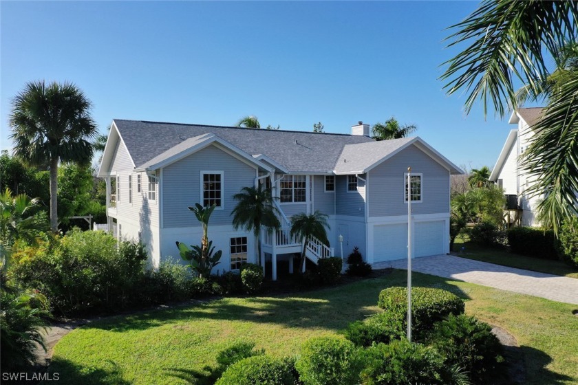 Sunset skies, pool and spa, curb appeal on a desirable - Beach Home for sale in Sanibel, Florida on Beachhouse.com