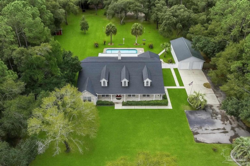 Sit on your wrap around porch and discover 4 acres of privacy in - Beach Home for sale in Pensacola, Florida on Beachhouse.com