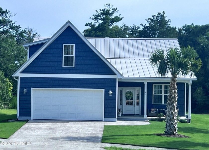 Nestled in the Maritime Forest, this home offers a metal roof - Beach Home for sale in Pine Knoll Shores, North Carolina on Beachhouse.com