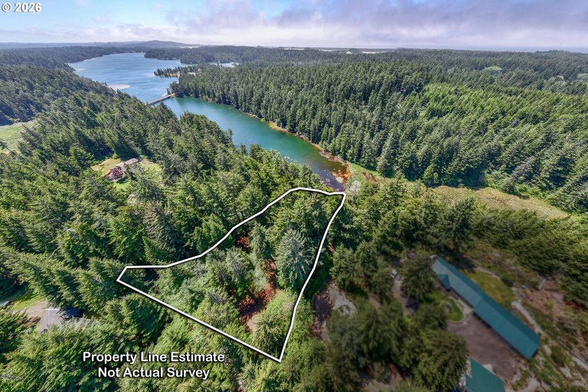 Tucked away in the trees on beautiful Woahink Lake, this rare 1 - Beach Lot for sale in Florence, Oregon on Beachhouse.com
