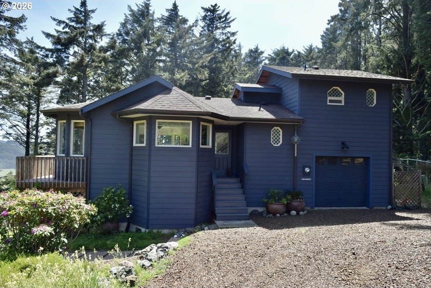Nestled on a beautifully landscaped one-acre parcel, this - Beach Home for sale in Gold Beach, Oregon on Beachhouse.com