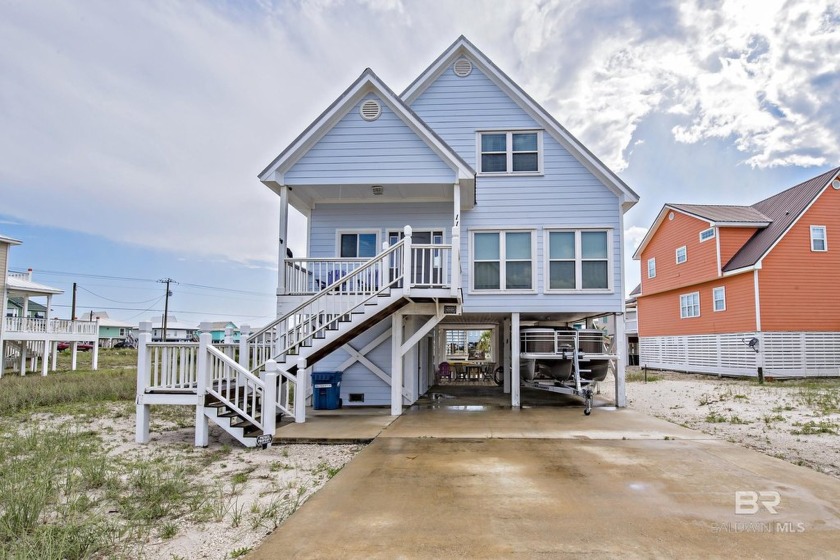 Nestled off of West Beach Blvd, this beach cottage is lagoon - Beach Home for sale in Gulf Shores, Alabama on Beachhouse.com