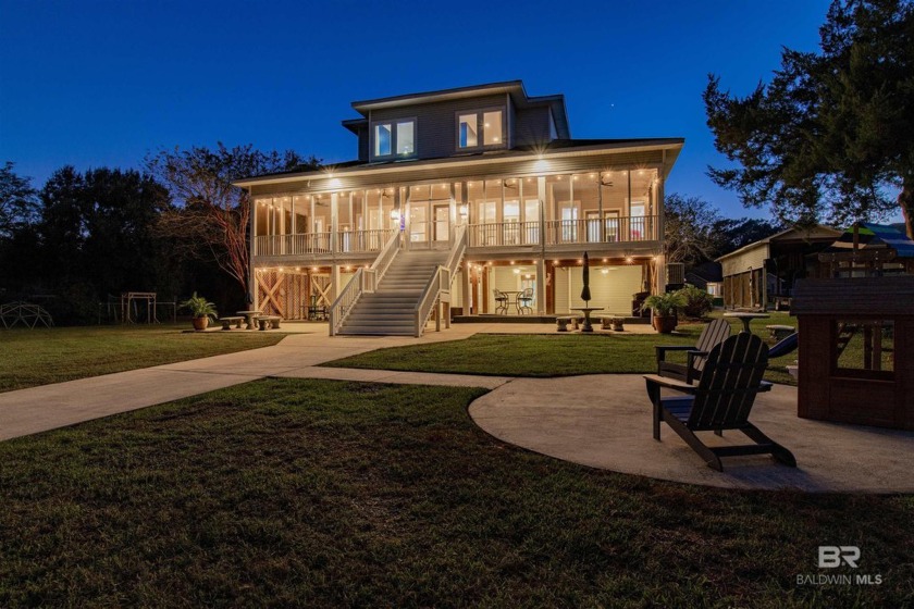 This stunning custom-built home, nestled along the serene shores - Beach Home for sale in Theodore, Alabama on Beachhouse.com