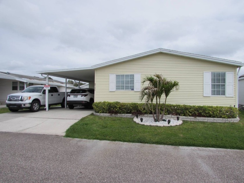 Enter from the extra wide driveway under the carport into the - Beach Home for sale in Trinity, Florida on Beachhouse.com