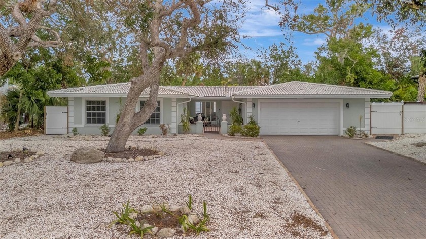 Under the canopy of grand oaks and banyan trees, this - Beach Home for sale in Sarasota, Florida on Beachhouse.com