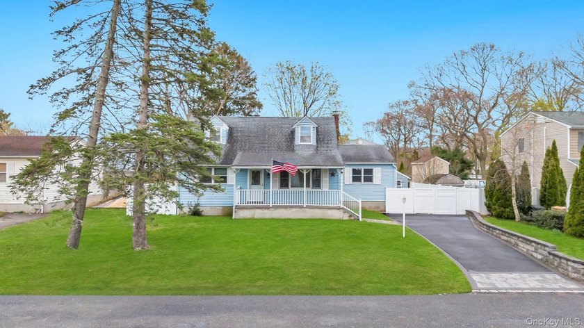 Welcome to this inviting 4-bedroom, 2-bathroom expanded Cape - Beach Home for sale in Shirley, New York on Beachhouse.com