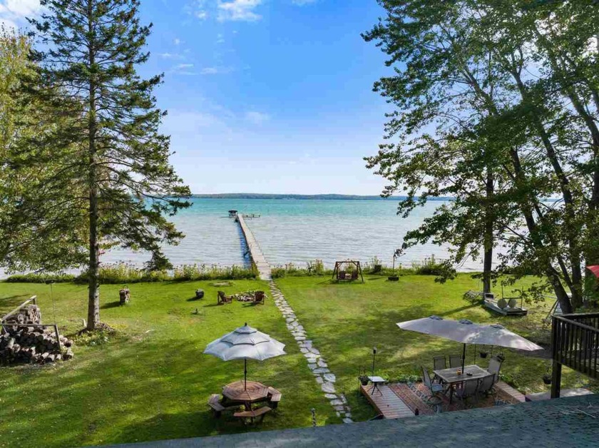 Beautiful Burt Lake log home for sale! Located on the sandy west - Beach Home for sale in Brutus, Michigan on Beachhouse.com